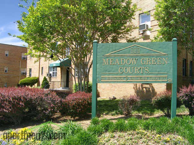 a green sign in front of a building